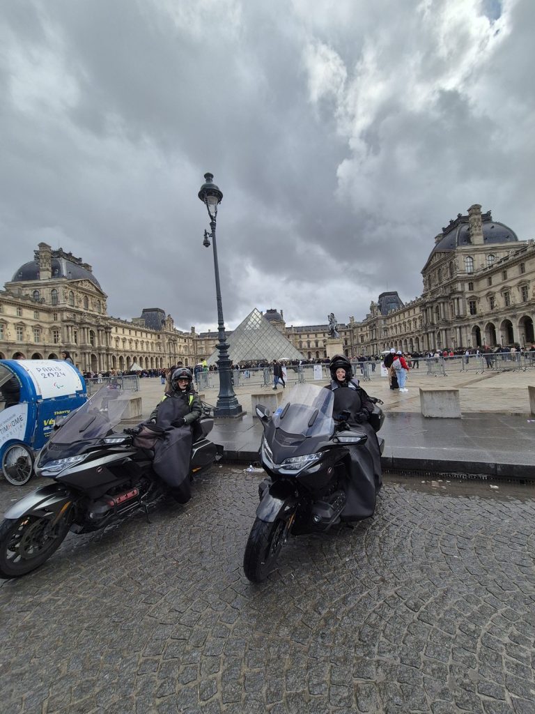 Balade à moto devant la pyramide du Louvre à Paris